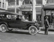 San Francisco circa  Chalmers touring car on Van Ness Avenue At FJ Linz Motor Co your Scripps-Booth dealer With a streetcar squeezing by
